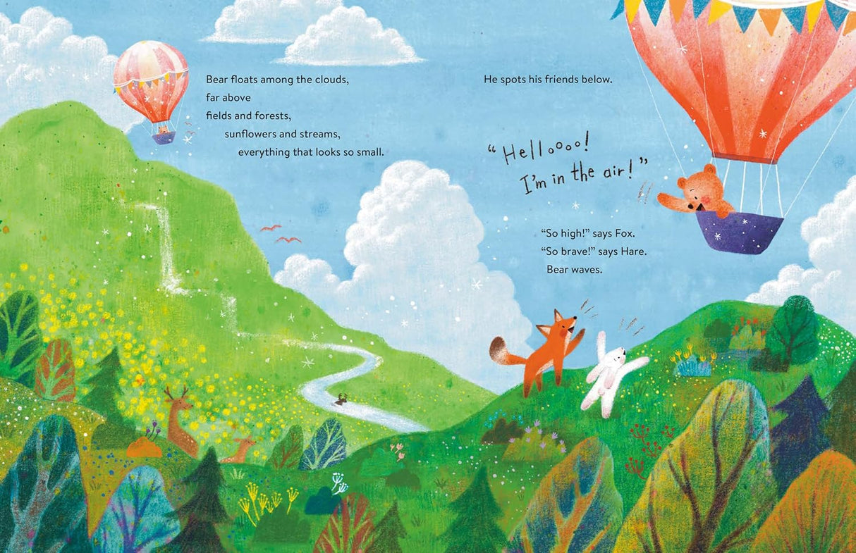 Bear in the Air shows a bear happily flying a hot air balloon above green hills and waving friends below.