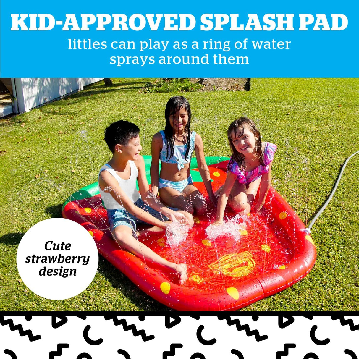 Three children sitting and splashing water on a red inflatable pool shaped like a strawberry on grass