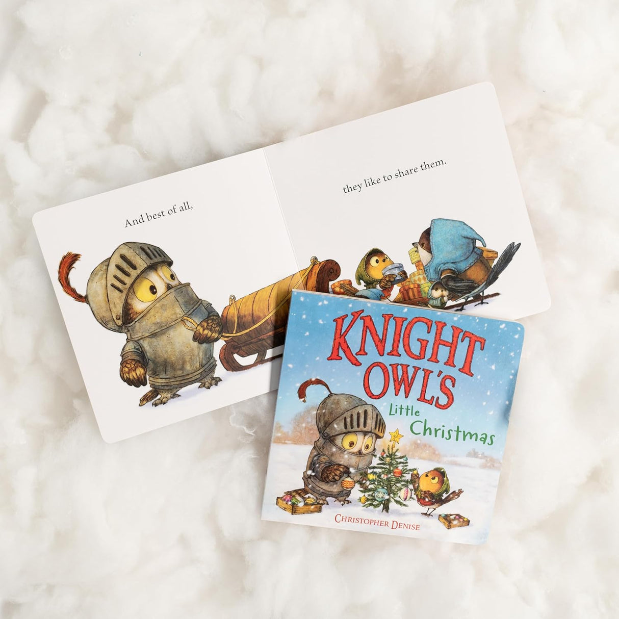 Open children's book Knight Owl's Little Christmas showing owl in armor and festive winter scene with friends sharing gifts