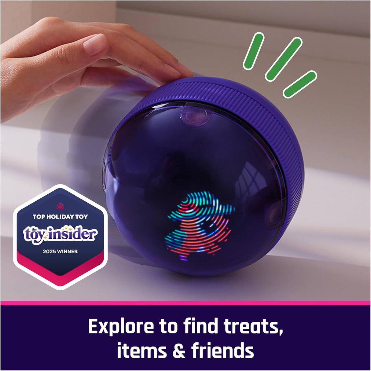 Hand touching a purple interactive hamster ball toy with colorful LED display on a white surface.