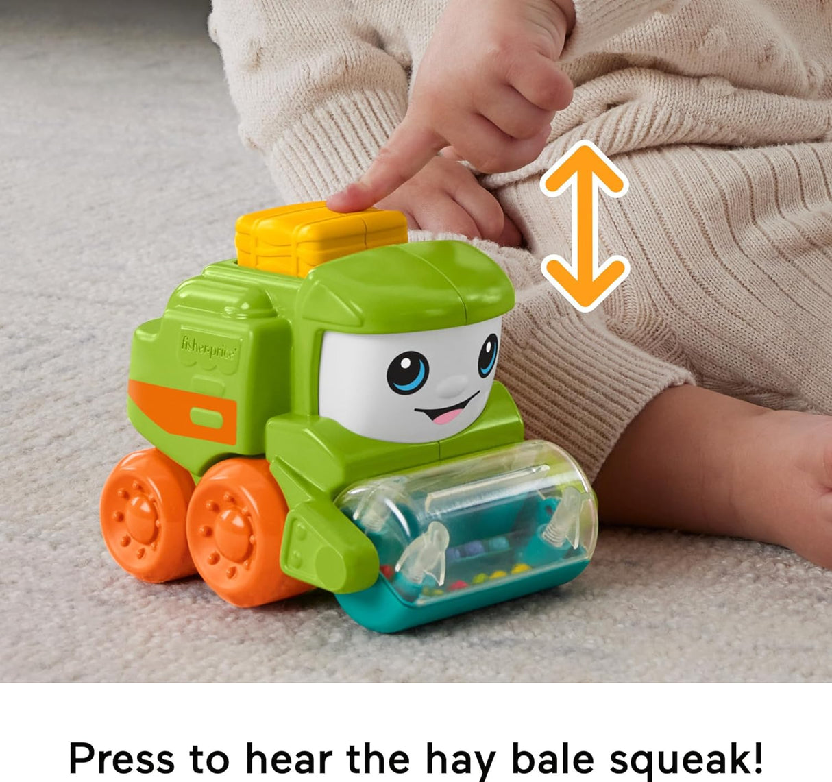 Little People Rollin' Tractor baby toy with bright colors, friendly face, and a hay bale squeaker for ages 6 months plus.