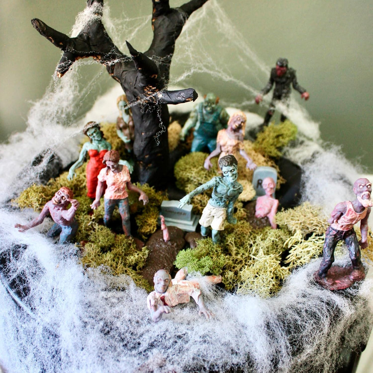 TOOB | Super Zombies! set showing detailed hand-painted zombie figurines around a spooky tree with cobwebs and moss.