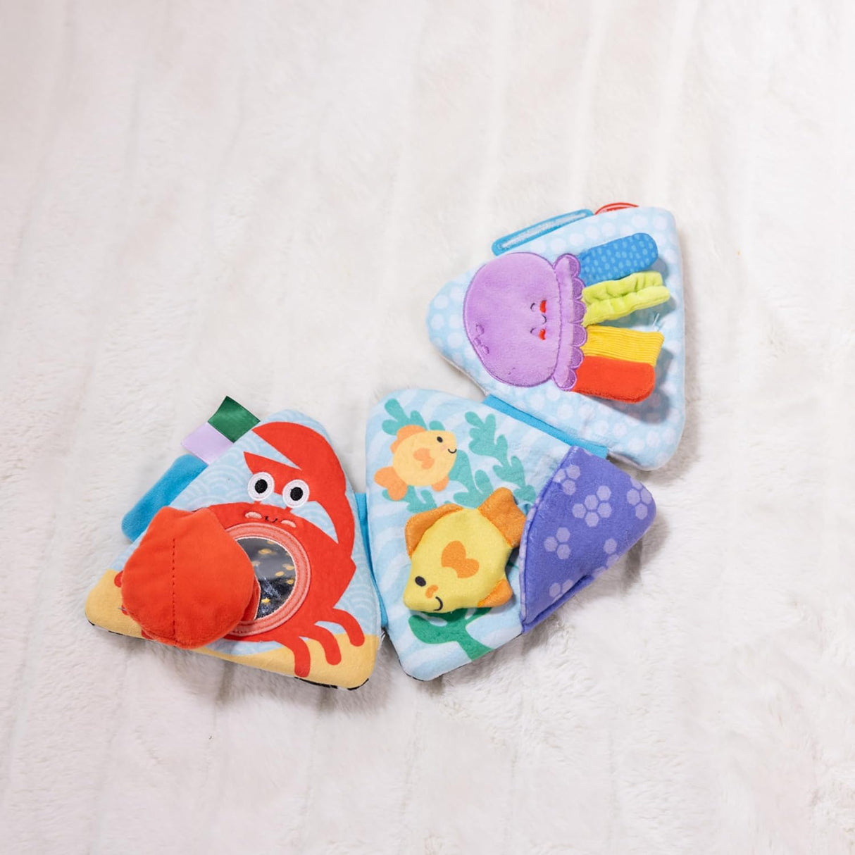 Ocean Tummy Time Triangle with fold-out panels featuring colorful sea creatures and sensory play elements.