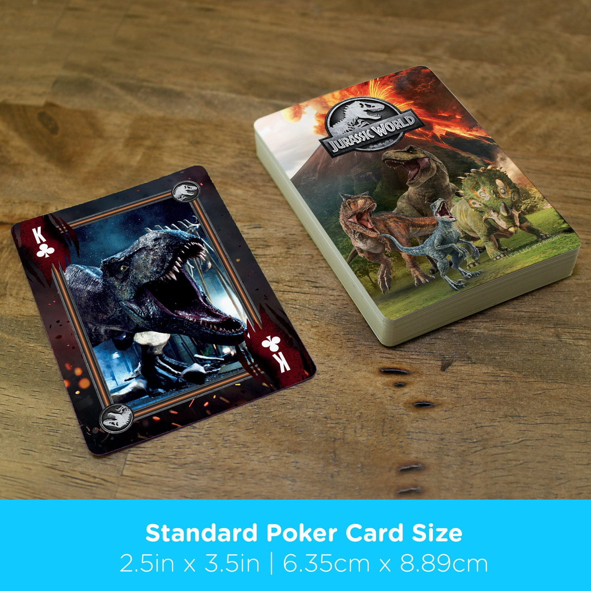 Jurassic World Playing Cards deck with dinosaur images, including T-Rex King of Clubs card on wooden surface.