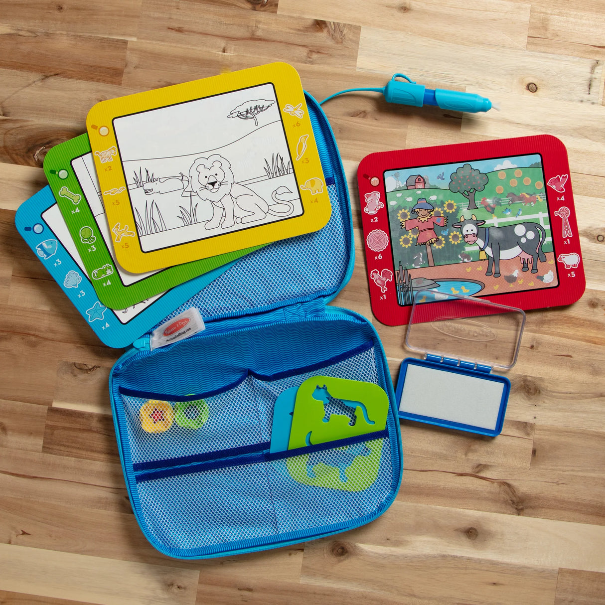 Colorful Water WOW! drawing set with animal-themed boards, water pen, and zip-open carrying case on wooden surface