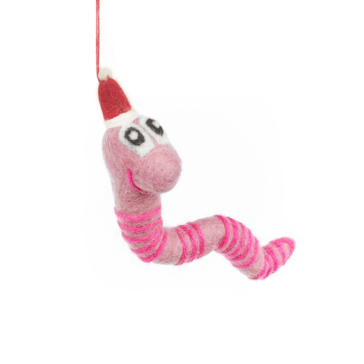 Pink and white felt earthworm ornament with big eyes and red hat hanging by a string against white background