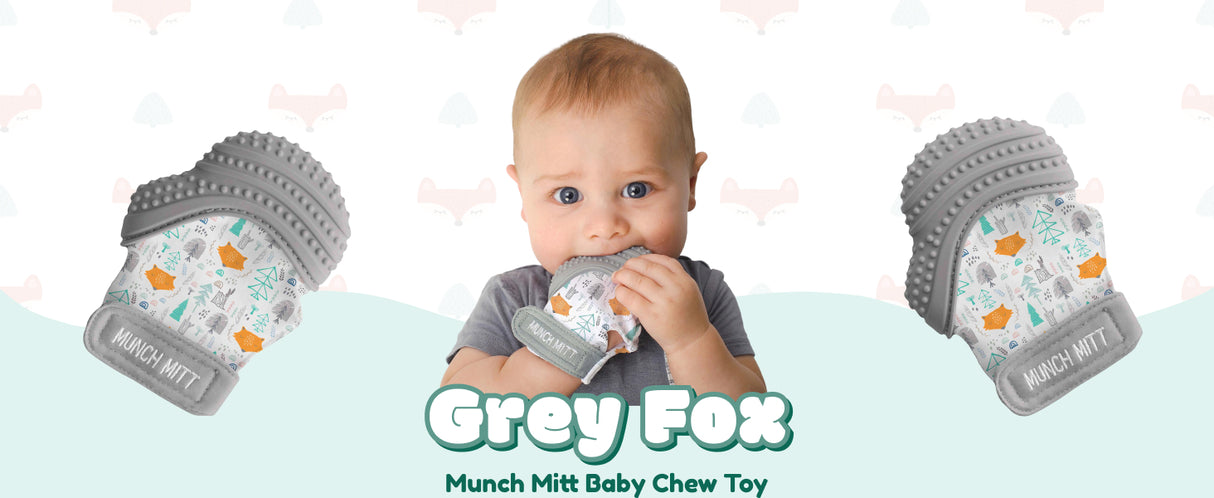 Munch Mitt | Grey Woodland teething mitt worn by baby with textured silicone surfaces for soothing gums.