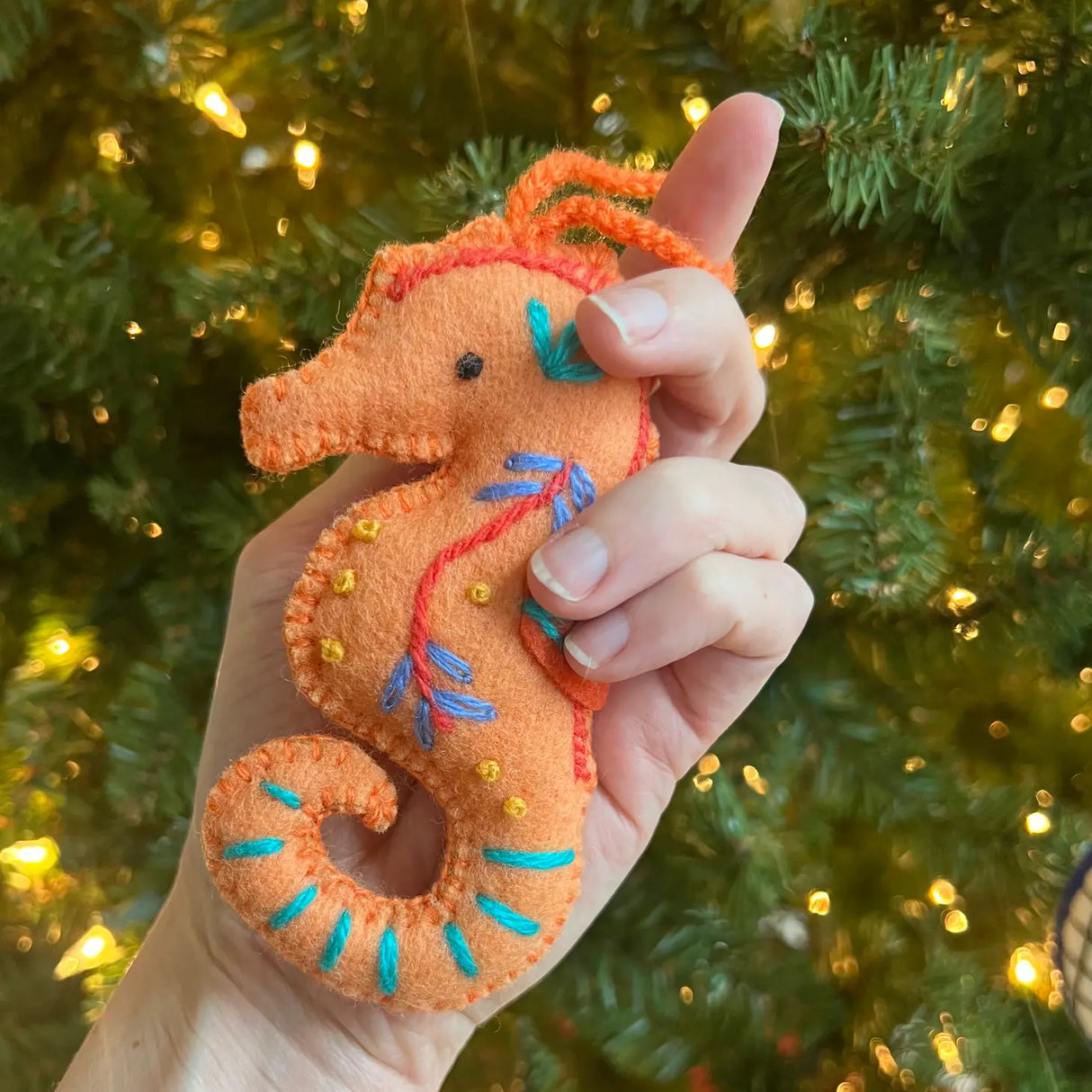 Handheld Seahorse Embroidered Felt Ornament in orange with colorful stitching, perfect for holiday decoration.