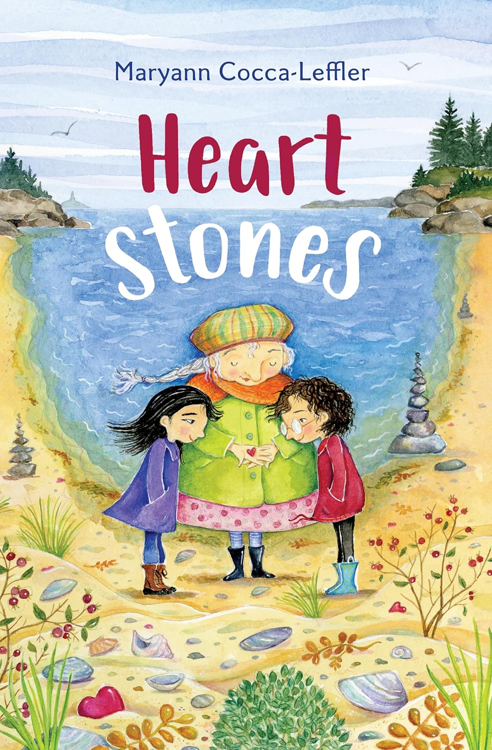 Heart Stones book cover showing three children by the shore holding a heart, with coastal scenery in the background.