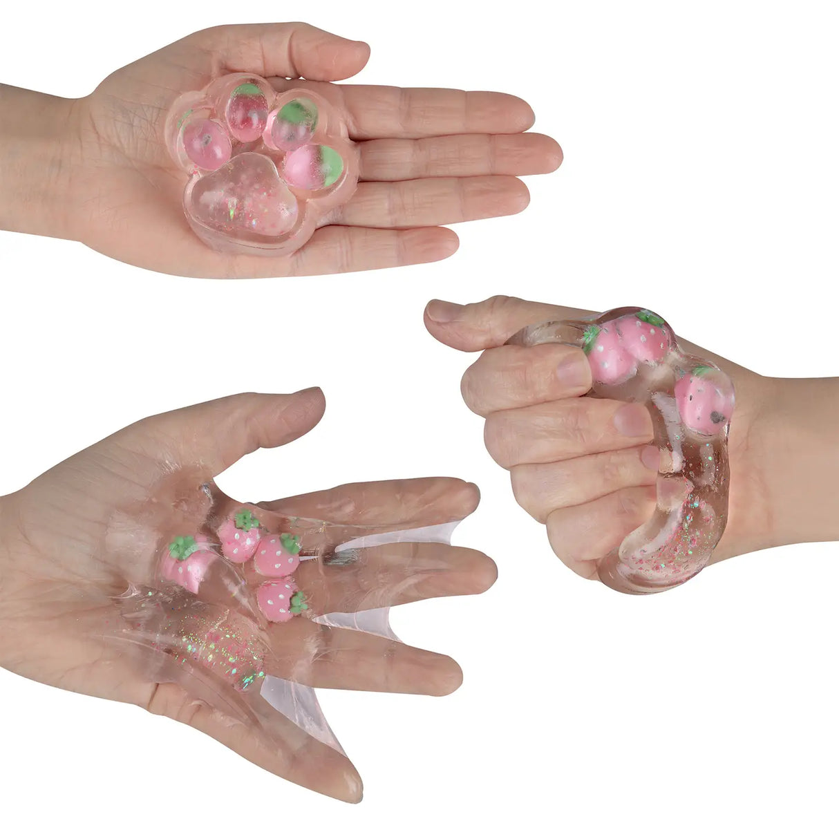 Taba-licious Mega Paws Squishy showing a clear, paw-shaped squishy with pink strawberry details in hand.