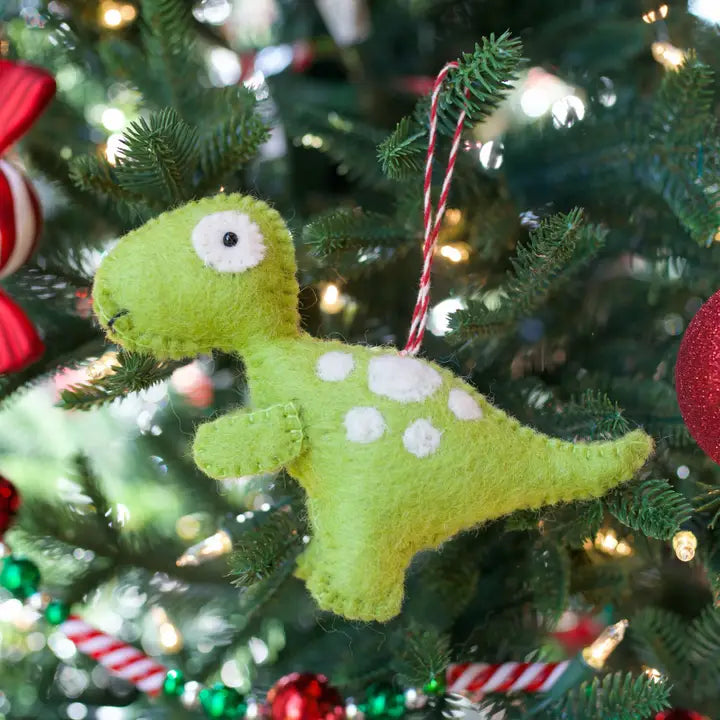 Green T Rex Felt Ornament hanging on Christmas tree with green and white wool felt and decorative lights
