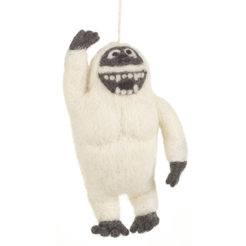 Felt ornament of a friendly yeti waving with a big smile made from soft wool material