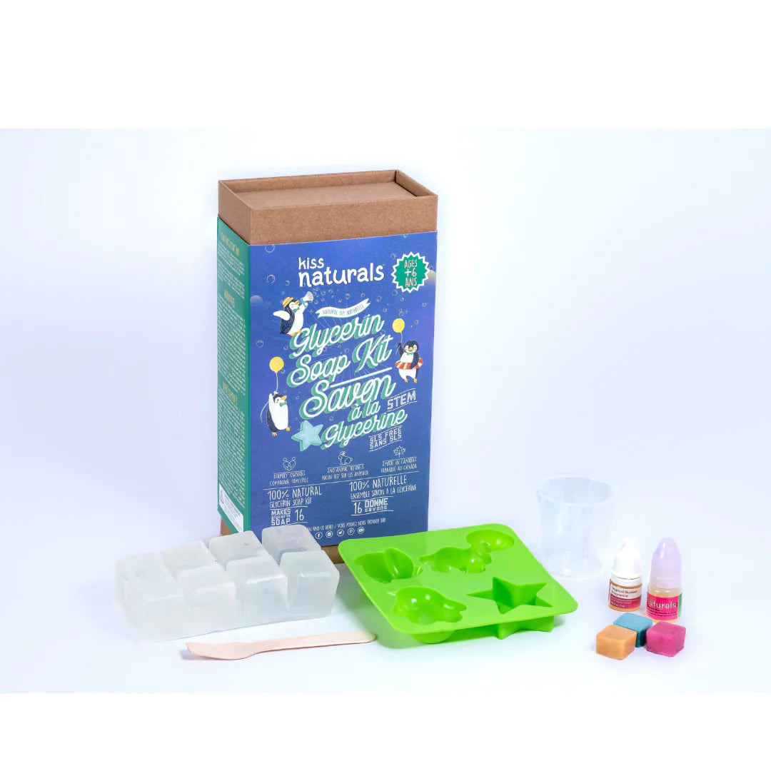 DIY Glycerin Soap Kit with clear soap base, silicone molds, color bars, scented oils, and measuring cup for kids craft.