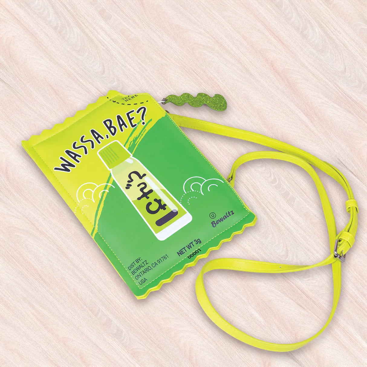 Crossbody Handbag | Wasabi shaped like a wasabi sauce packet with a bright yellow and green playful design.