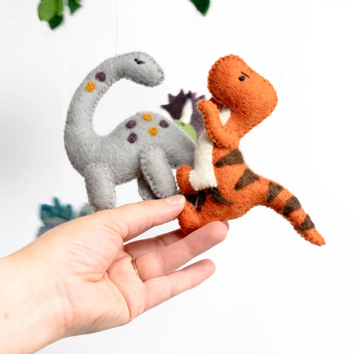 Felt Mobile | Baby Dinosaur with handmade wool felt gray and orange dinosaur figures for nursery decor and baby gifts.