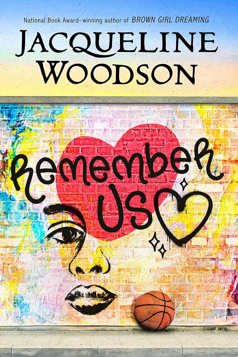 Cover of Remember Us by Jacqueline Woodson featuring colorful graffiti art with a heart and basketball.