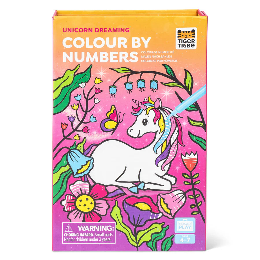 Colorful box with a white unicorn surrounded by vibrant flowers and a butterfly on a pink and orange background