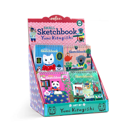 Small Sketchbook | Yumi Kitagishi display with colorful, spiral-bound sketchbooks featuring playful animal artwork.