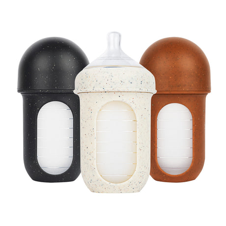 NURSH Silicone Bottles | Speckle in black, white, and brown with air-free silicone pouch for colic-free feeding.
