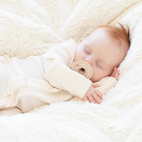 Sleeping baby peacefully using Pacifier | Cheeks for Weeks made of soft silicone for comfort.