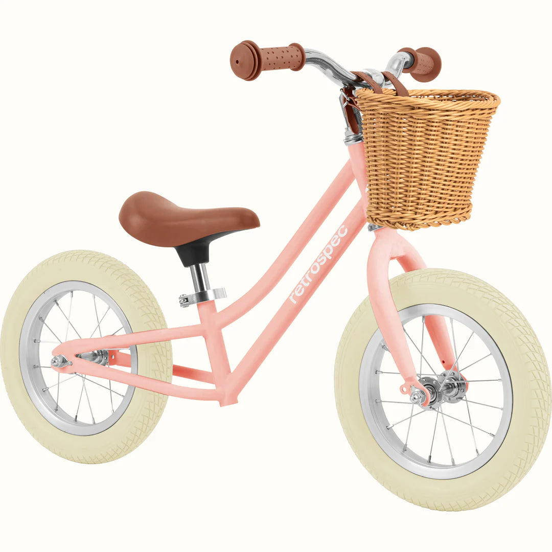 Baby Beaumont Balance Bike | Blush with adjustable seat, air-filled tires, step-through frame, and front wicker basket for toddlers.