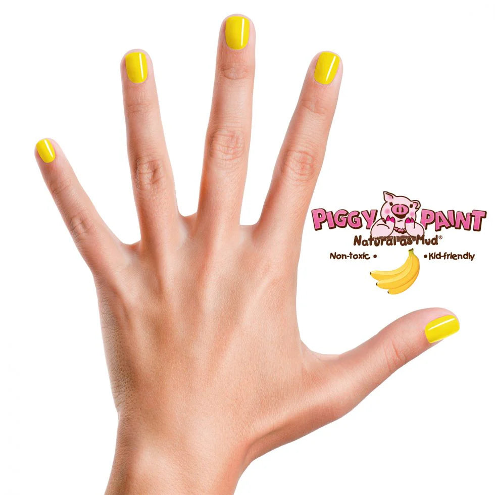 Hand with bright sunshine yellow nails painted with Nail Polish Scented Banana Besties by Piggy Paint.