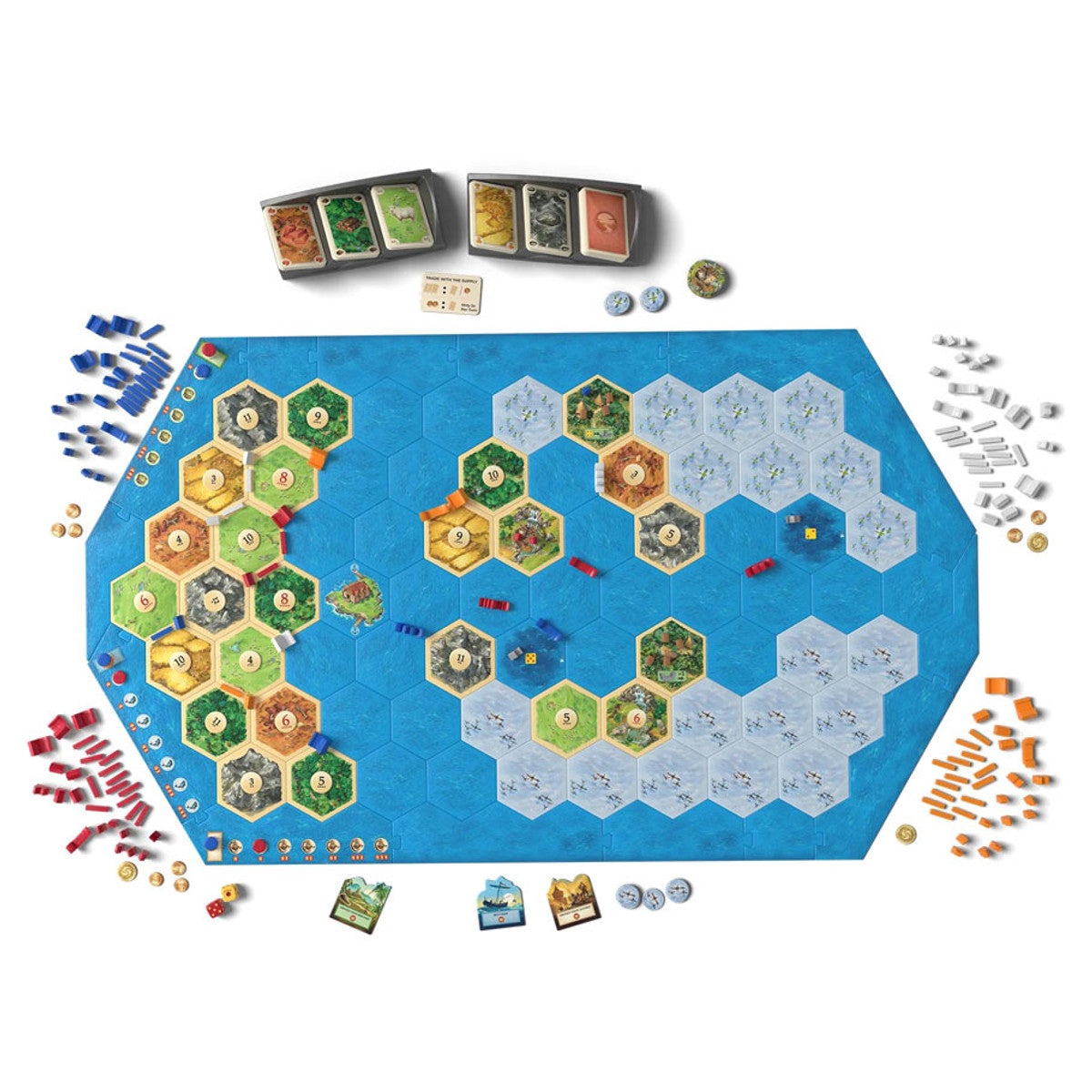Board game setup for Catan Explorers and Pirates Expansion 6th Edition with tiles, cards, and pieces on a blue hex map
