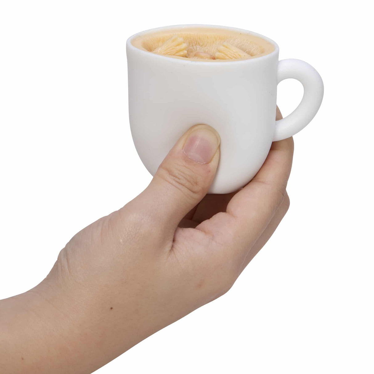 Hand holding a squishy espresso cup with latte art showing Pup in a Cup! toy for squeezable play.
