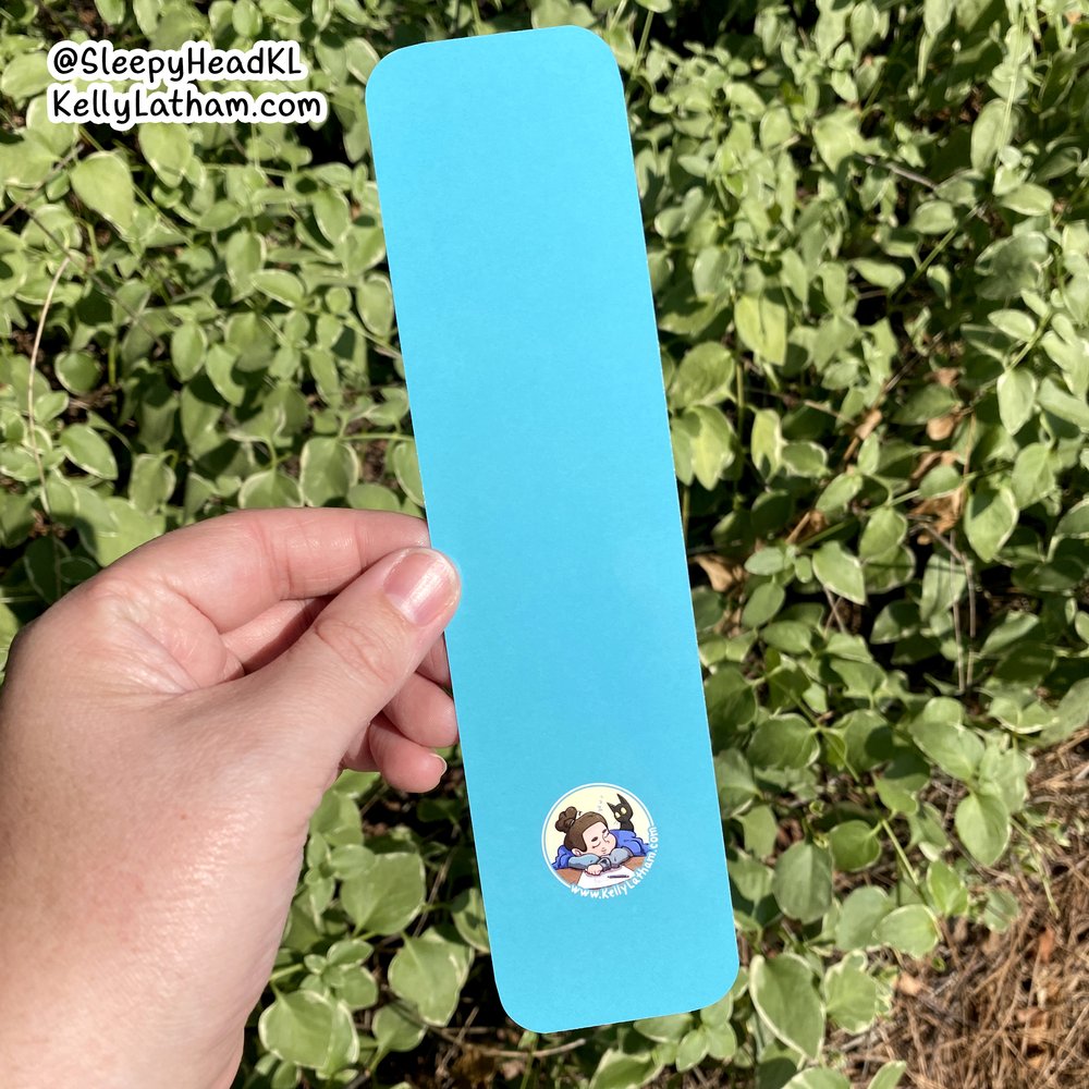 Cat & Flowers Bookmark showing solid turquoise back with artist logo on glossy high-quality paper.
