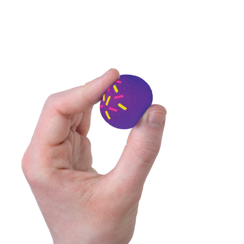 Hand holding a purple NeeDoh Dohnut Holes toy with yellow and pink sprinkles for sensory play.