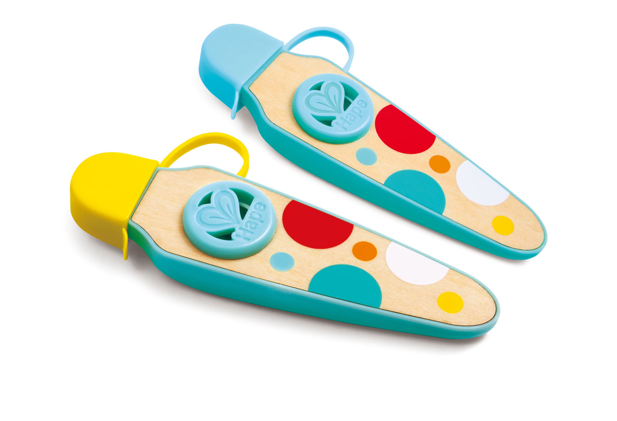 Two colorful wooden pocket kazoos with blue, yellow, red, and white polka dot designs on a white background