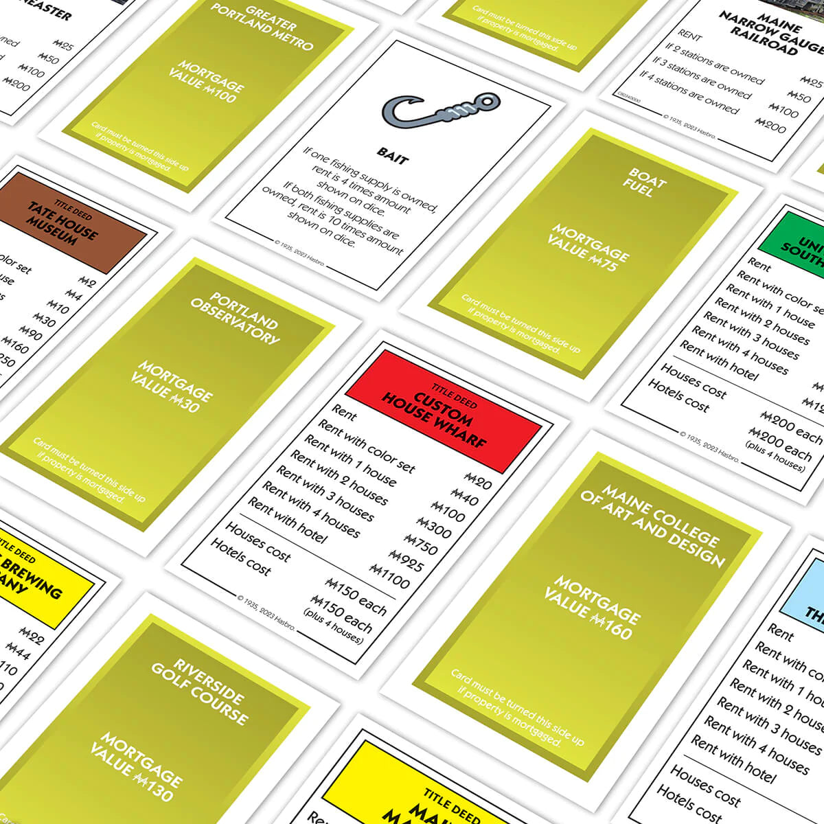 Monopoly Portland, Maine Edition game cards showcasing local landmarks and unique property deeds on the game board.