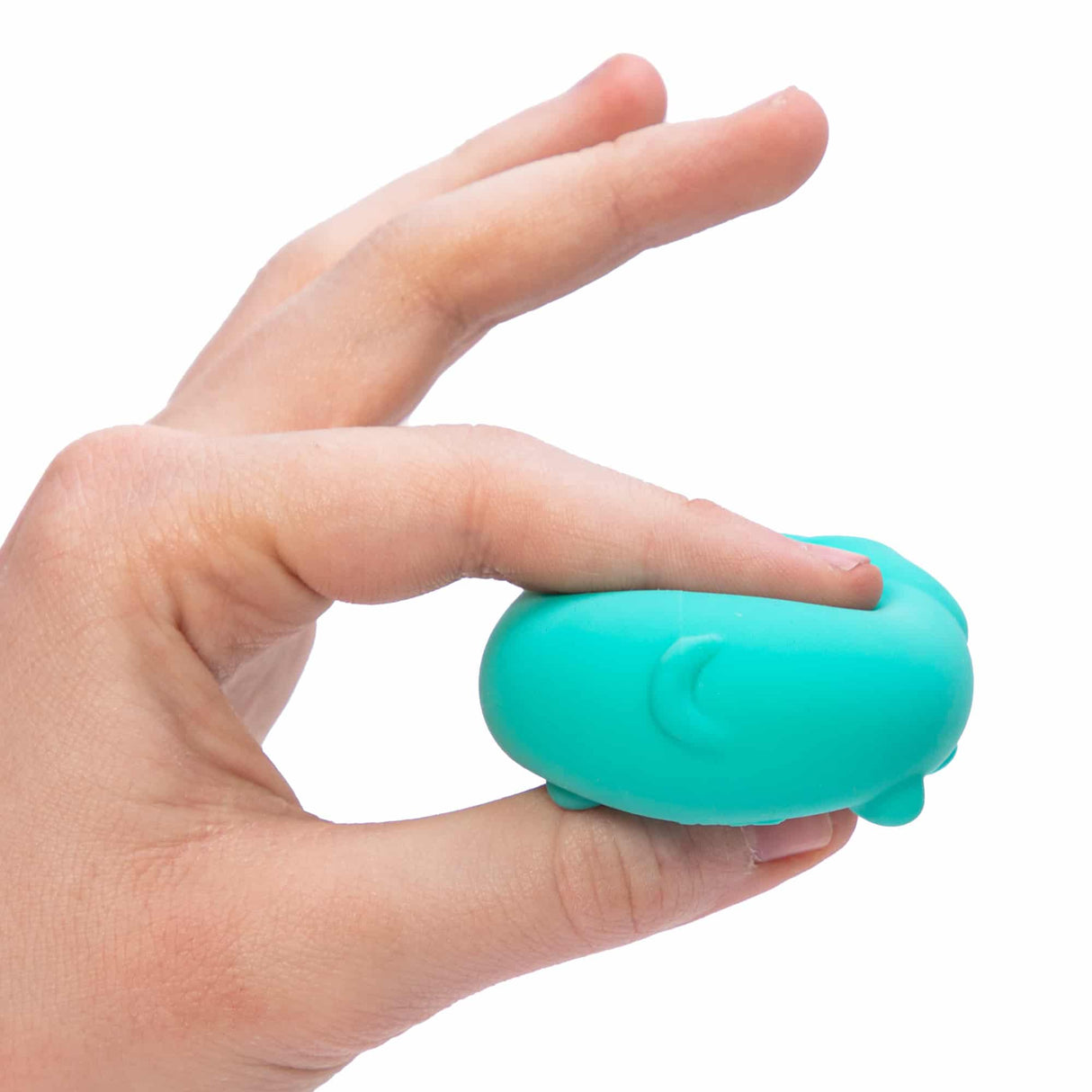 Hand squeezing a small blue NeeDoh Teenie Funky Pup dough-filled toy with playful facial features.