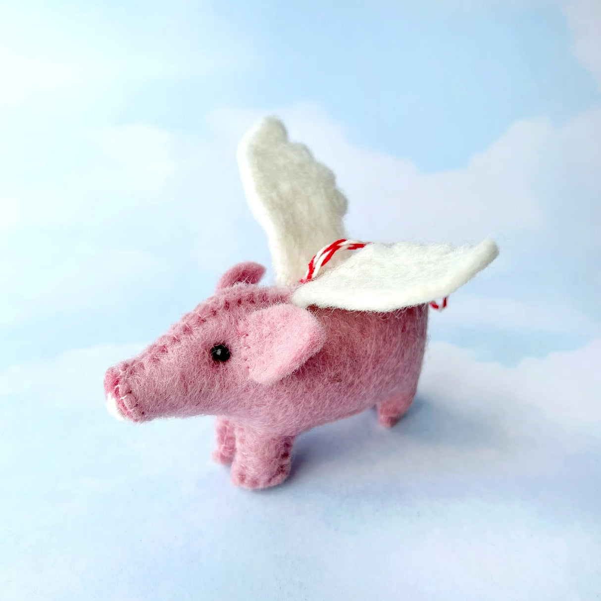 Flying Pig Felt Ornament handcrafted in Nepal with pink wool and white wings, perfect whimsical holiday decor.