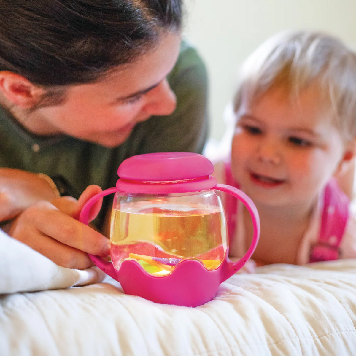 Mini Sensory Jar | Pink with a child exploring the liquid-filled sensory jar alongside an adult