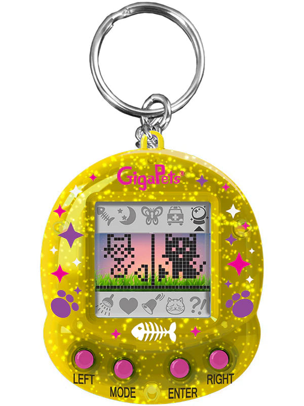 GigaPets Starcat Compukitty virtual pet toy with yellow glitter case and pixelated cat characters on screen.