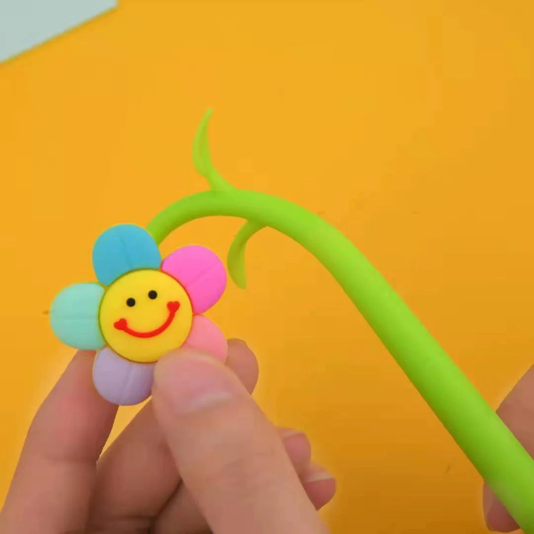 Close up of Smile Flower Wiggle Gel Pen with colorful smiling flower head and flexible green stem held by hand