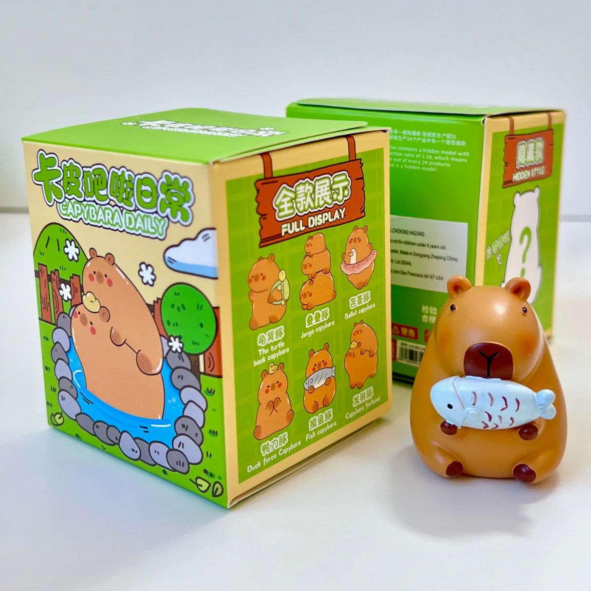 Capybara Life Blind Box with a cute resin capybara figurine holding a fish, featuring assorted animal designs.