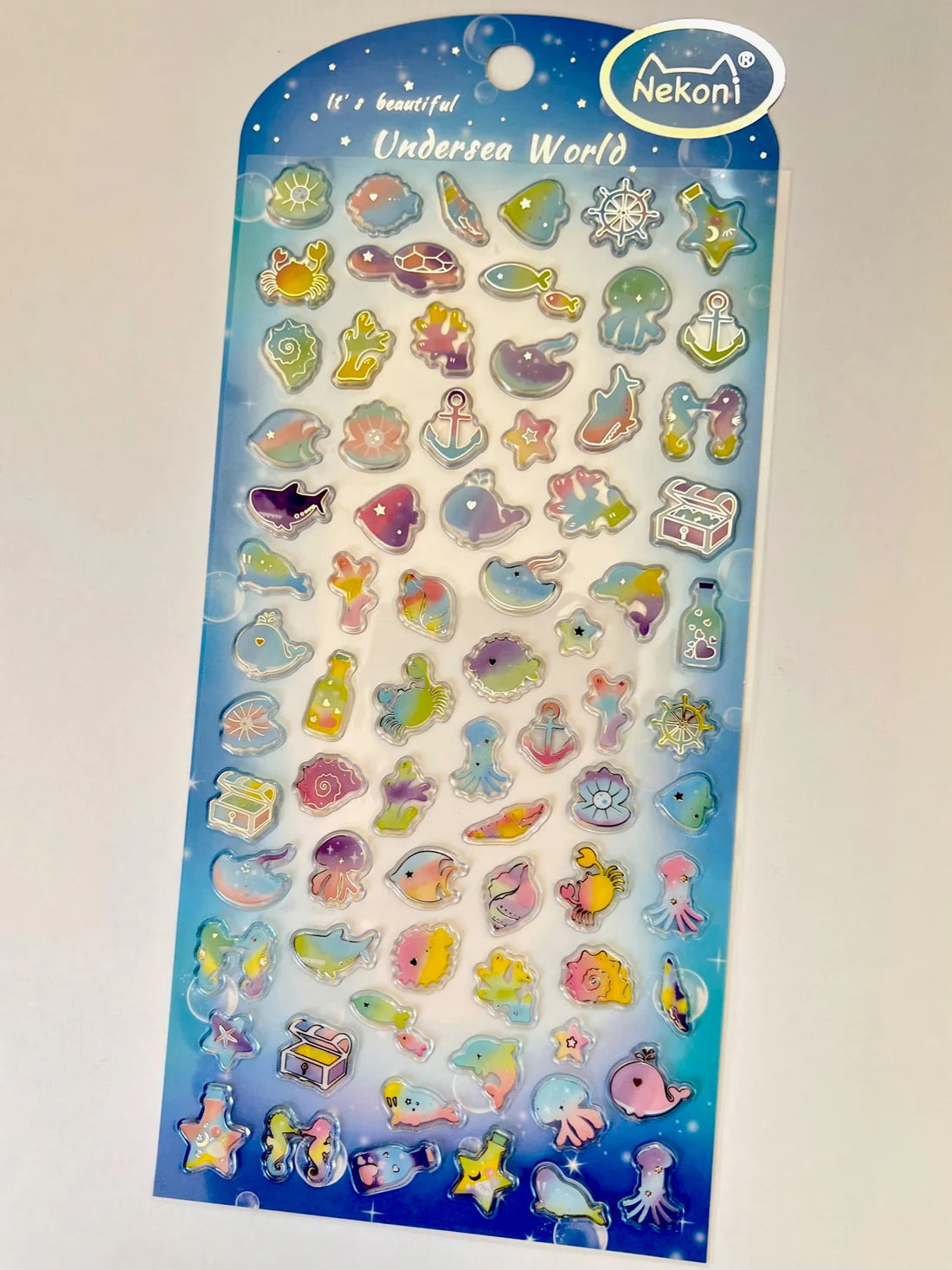 Ocean Shiny Rainbow Stickers featuring colorful undersea creatures and objects on one sheet for creative decoration.
