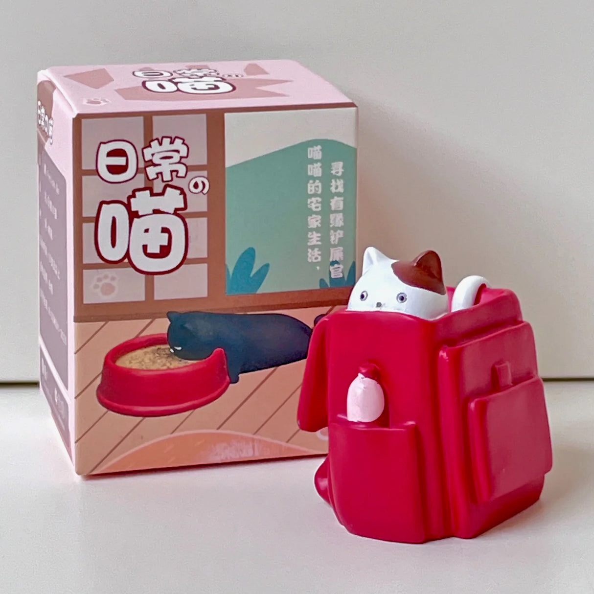 House of Cats Blind Box featuring a mystery cat figure hiding in a red backpack collectible toy.