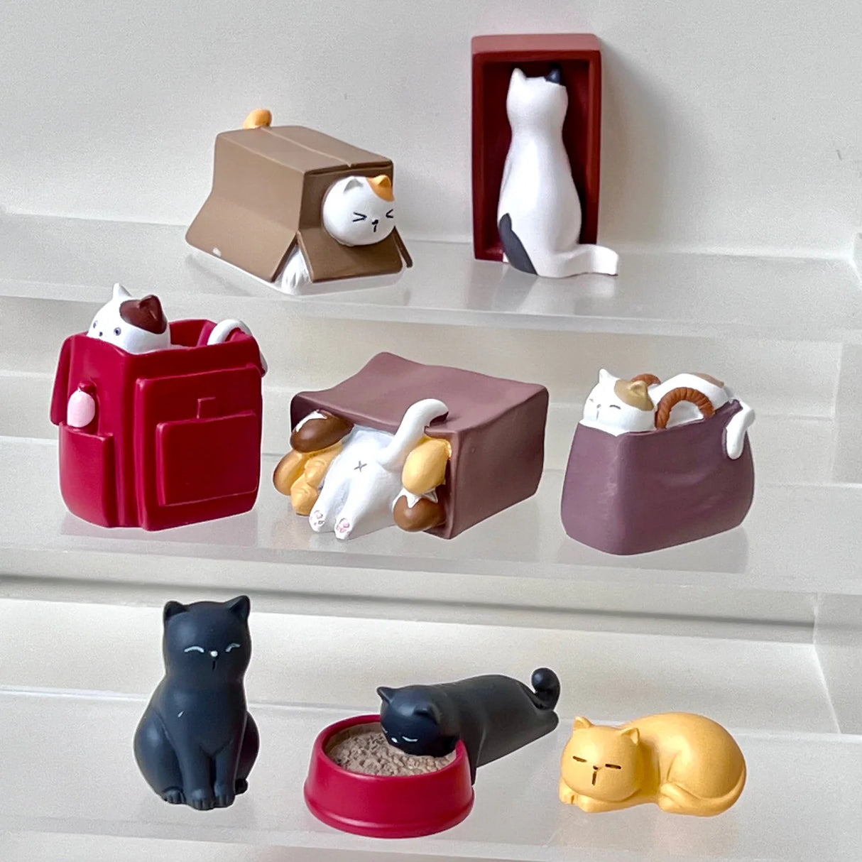 House of Cats Blind Box showing mystery cat figures in playful poses and cozy hiding spots on display shelves.