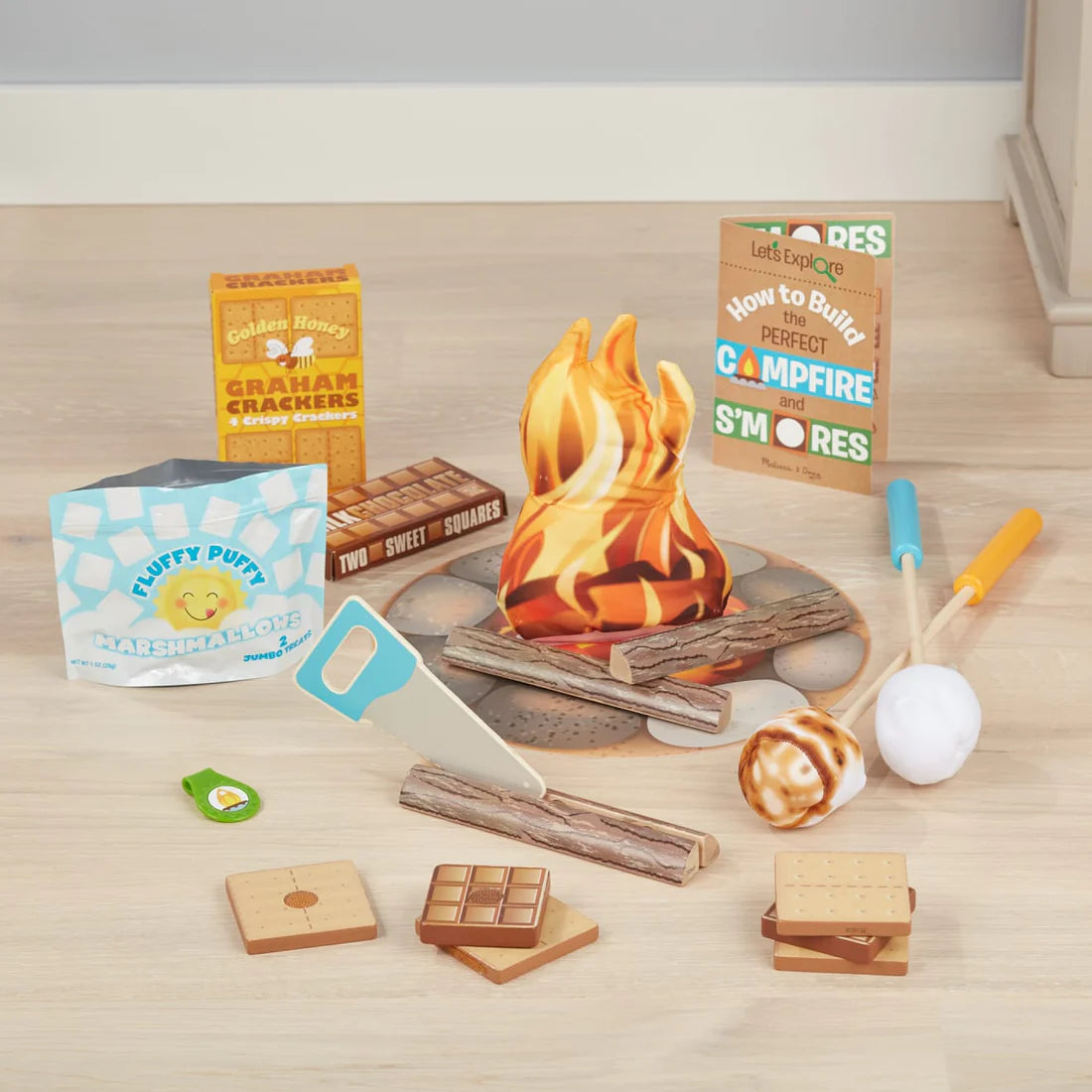 Let's Explore Campfire S'mores Play Set with wooden graham crackers, chocolate, marshmallows, flames, saw, and activity card.