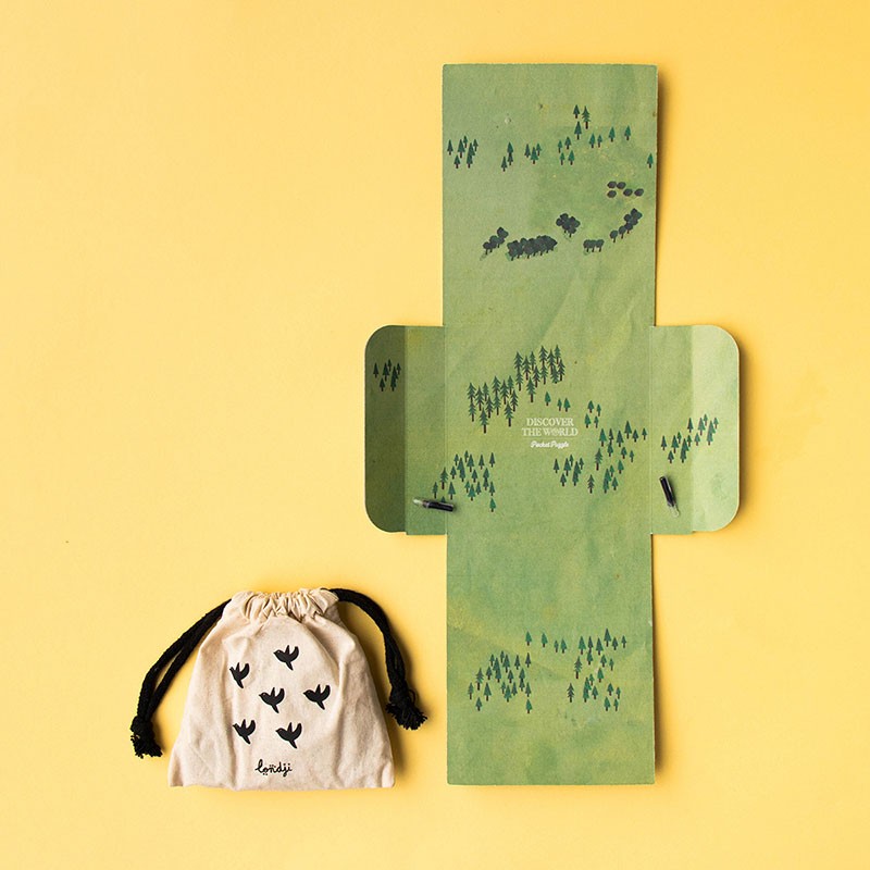 100pc Discover the World Pocket Puzzle with foldable map and cute fabric pouch on yellow background.