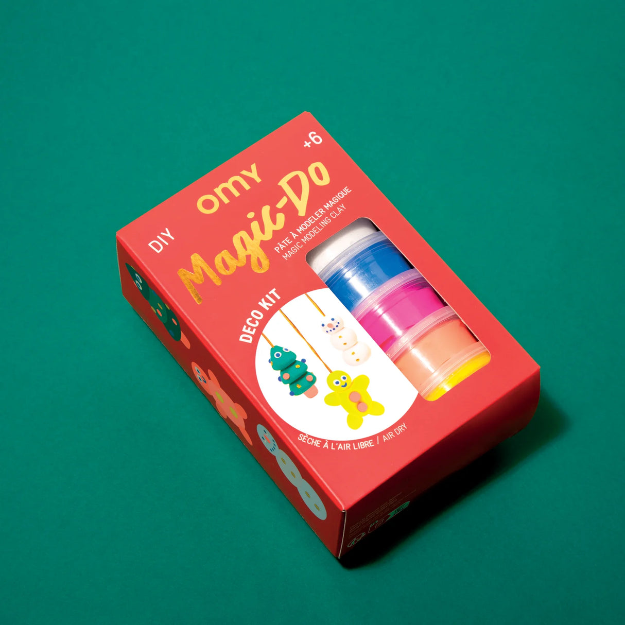 DIY Magic-Do Clay Ornaments kit with colorful clay tubs and holiday decoration images on red packaging box.