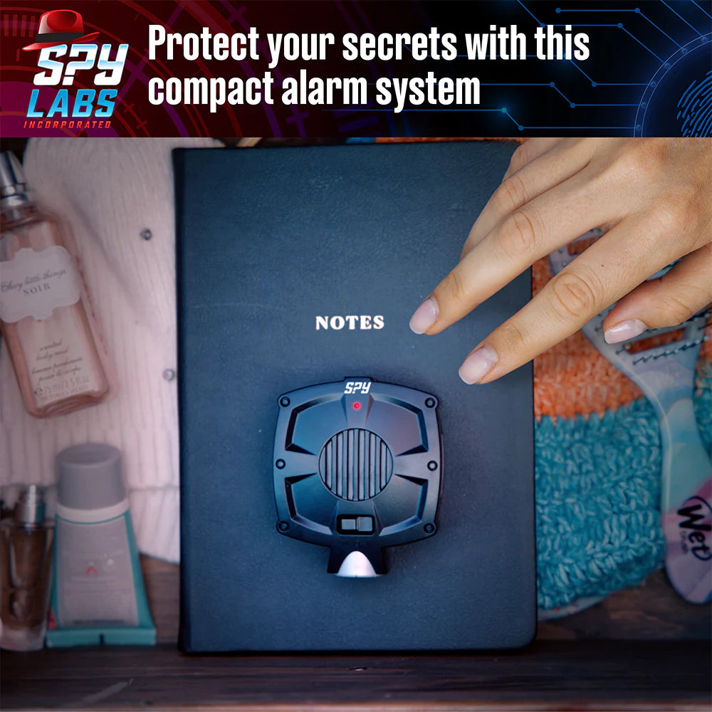 Spy Labs Motion Detector Alarm attached to a notebook detecting motion to protect personal notes and secrets.