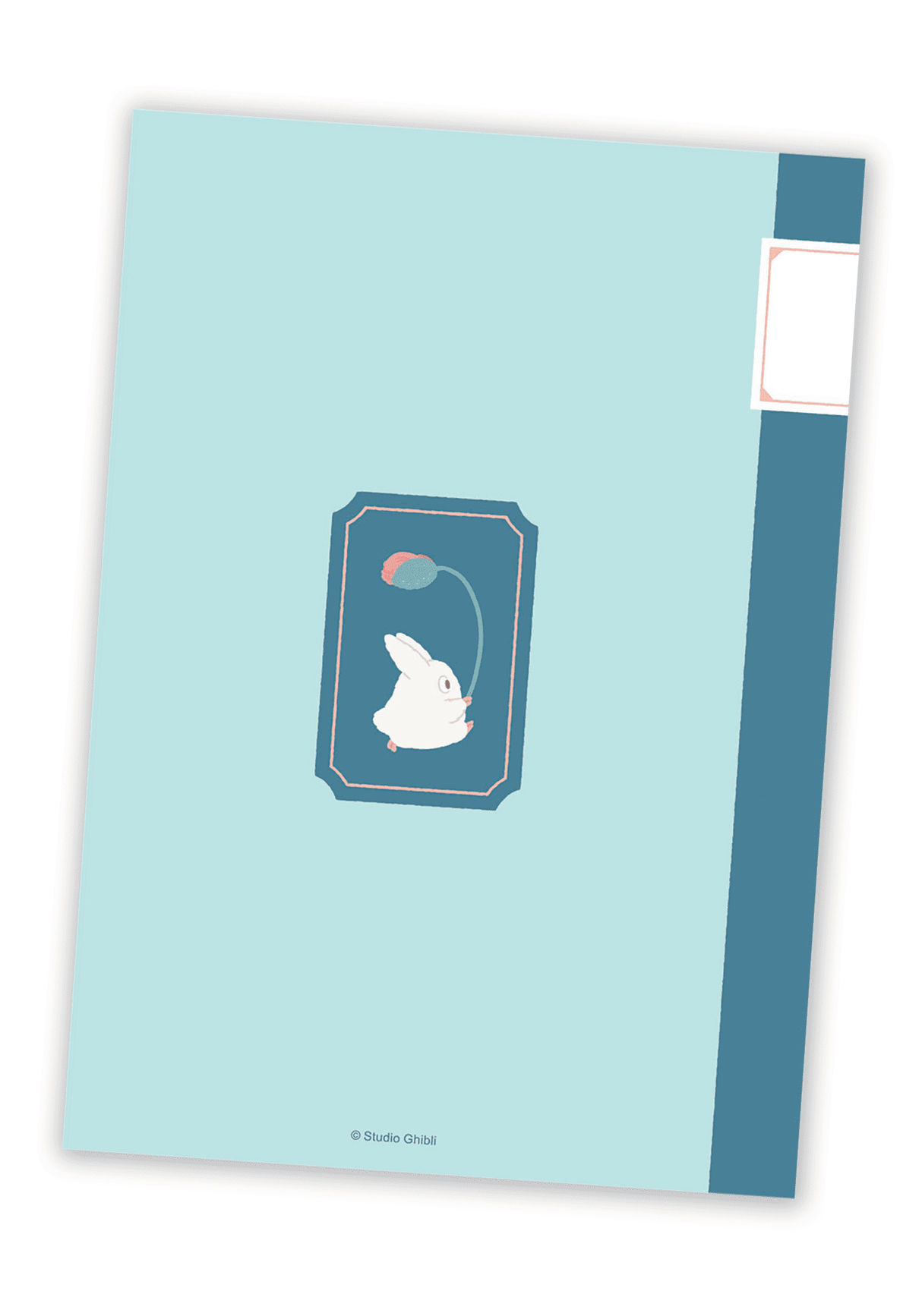 Back of B6 notebook with small Totoro friend holding a flower in the center.