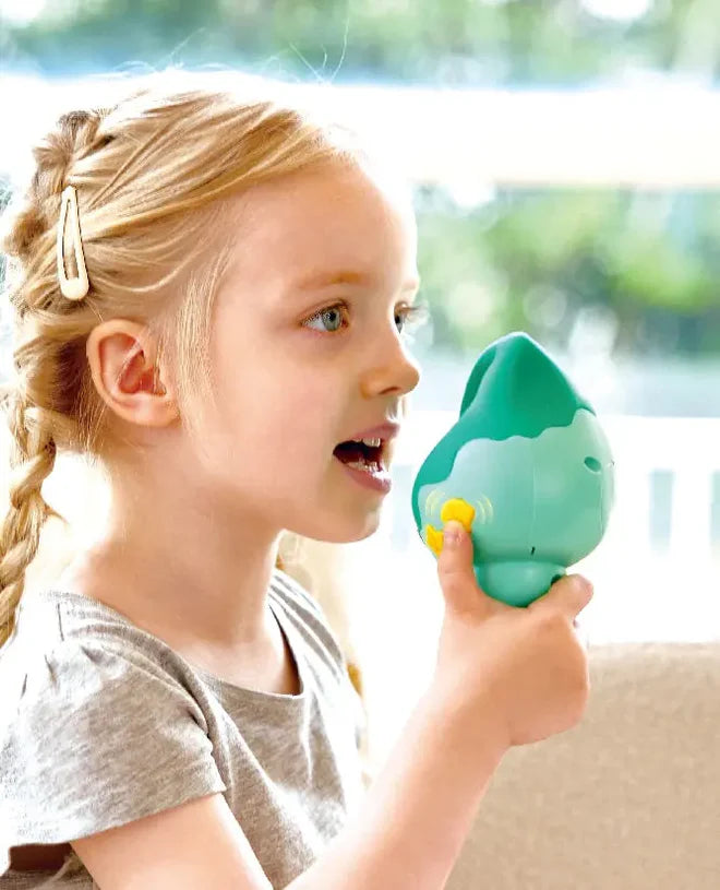 Young girl holding and speaking into the Magic Music Conch toy with sound and voice effects features.