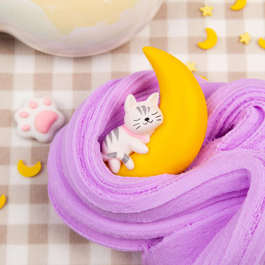 Neko Nap Cloud Creme Slime in lavender with a cute cat and crescent moon on a checkered cloth background.