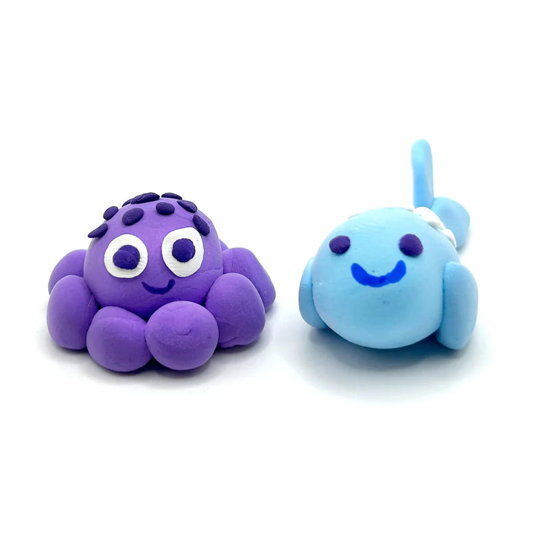 Creatibles Air Dry Clay Kit Ocean BFFs showing handmade purple octopus and blue whale clay figures on white background.