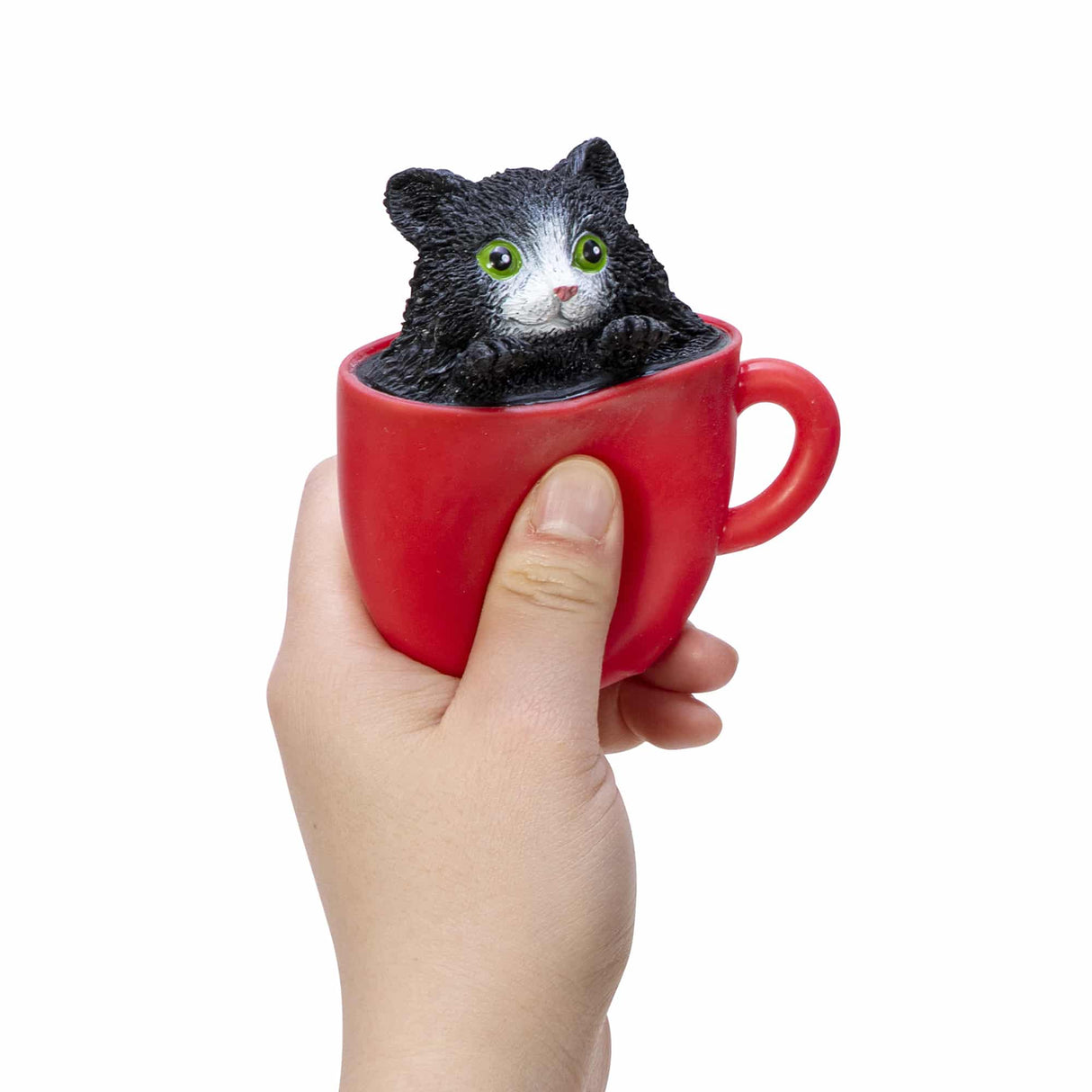 Hand holding a red cup with a black and white kitten popping out in the Pop a Chino Kitties! collectible toy.